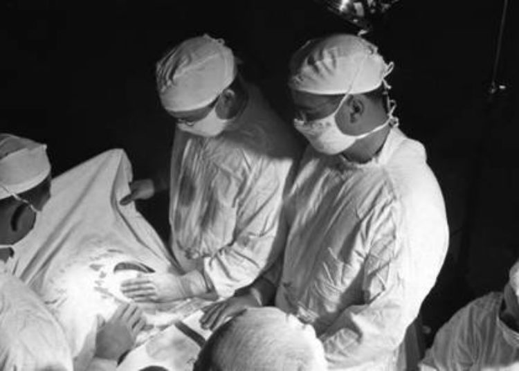 Outer glove exchange and paper surgical gowns decrease bacterial contamination