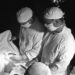 Outer glove exchange and paper surgical gowns decrease bacterial contamination